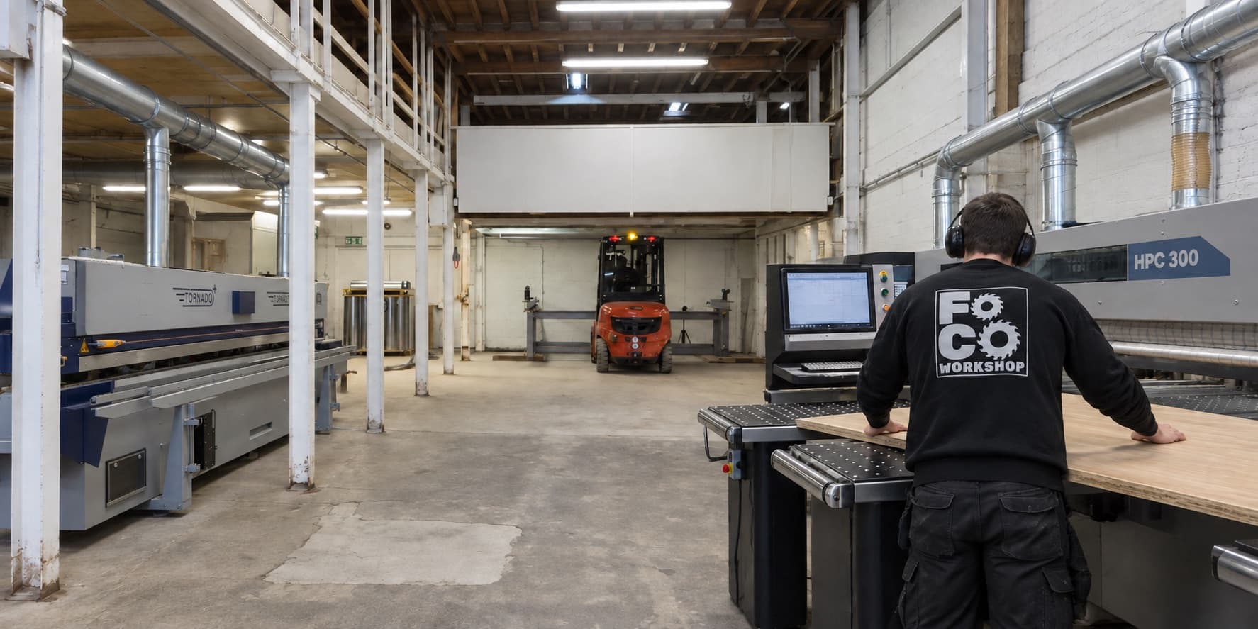 FOCO Workshop machinist loading a panel at the beam saw on the shop floor